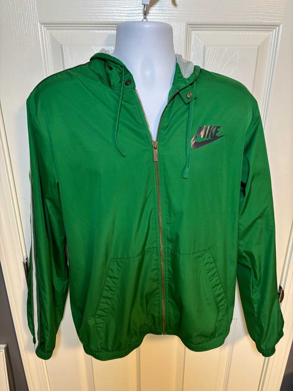 Nike green zip up windbreaker jacket with hood and navy logo, size M
